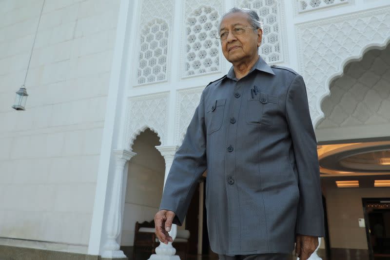 Malaysia's former Prime Minister Mahathir Mohamad leaves after an interview with Reuters in Kuala Lumpur