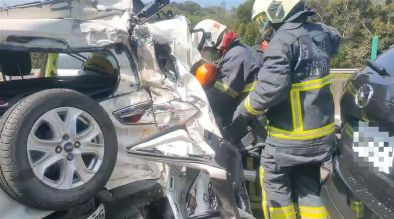 白色自小客車遭受猛力撞擊，車尾嚴重變形，後座2名乘客被夾在車內，其中1人被救出時已無生命跡象，經搶救仍宣告不治。(圖／翻攝畫面)