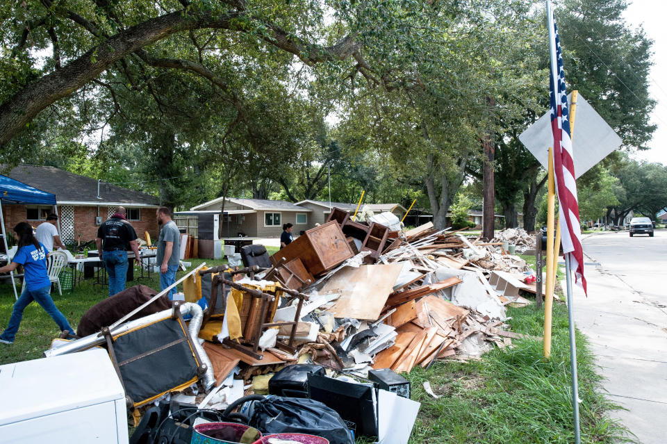 Crews&nbsp;of volunteers help locals in Katy rip out damaged furniture, roofing, flooring and wood from homes. (Photo: Joseph Rushmore for HuffPost)