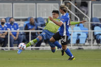 Seattle Sounders defender Xavier Arreaga, left, vies for the ball against San Jose Earthquakes forward Cade Cowell (44) during the first half of an MLS soccer match Wednesday, May 12, 2021, in San Jose, Calif. (AP Photo/Tony Avelar)