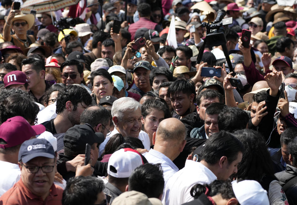 Mexican President Andrés Manuel Lopez Obrador, center, joins a march in support of his administration, in Mexico City, Sunday, Nov. 27, 2022. (AP Photo/Fernando Llano)