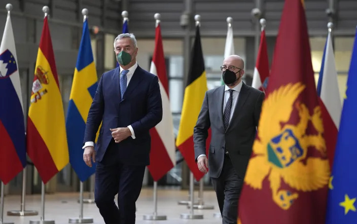 European Council President Charles Michel, right, walks with Montenegro's President Milo Dukanovic prior to a meeting at the European Council building in Brussels, Monday, Feb. 21, 2022. (AP Photo/Virginia Mayo)