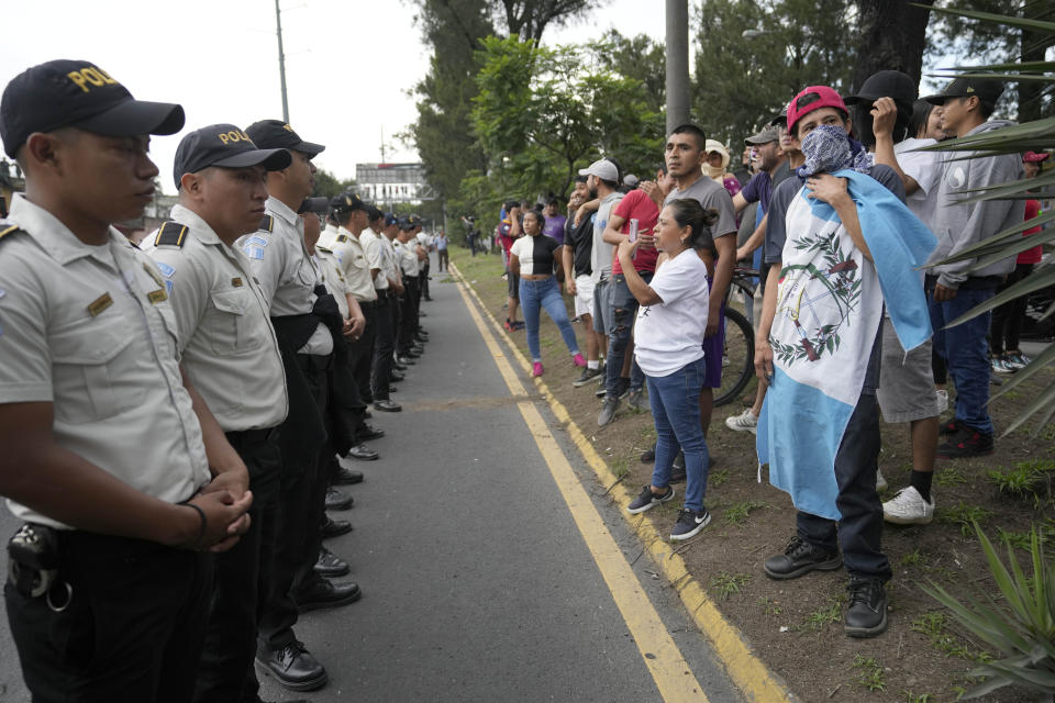 Police confront demonstrators during a national strike, in Guatemala City, Tuesday, Oct. 10, 2023. People are protesting to support President-elect Bernardo Arévalo after Guatemala's highest court upheld a move by prosecutors to suspend his political party over alleged voter registration fraud. (AP Photo/Moises Castillo)