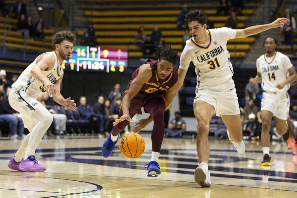 Arizona State guard Braelon Green, center, momentarily loses his dribble between California defenders Devin Askew, left, and Gus Larson (31) during the first half of an NCAA college basketball game, Sunday, Dec. 31, 2023, in Berkeley, Calif. (AP Photo/D. Ross Cameron)