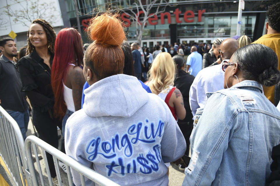 A guest wearing a sweatshirt stating "Long Live Hu$$le" attends the Celebration of Life memorial service for late rapper Nipsey Hussle, whose given name was Ermias Asghedom, on Thursday, April 11, 2019, at the Staples Center in Los Angeles. (Photo by Chris Pizzello/Invision/AP)