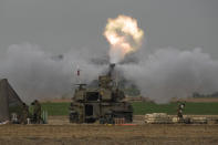 An Israeli mobile artillery unit fires a shell from southern Israel towards the Gaza Strip, in a position near the Israel-Gaza border on Sunday, Dec. 10, 2023. (AP Photo/Leo Correa)