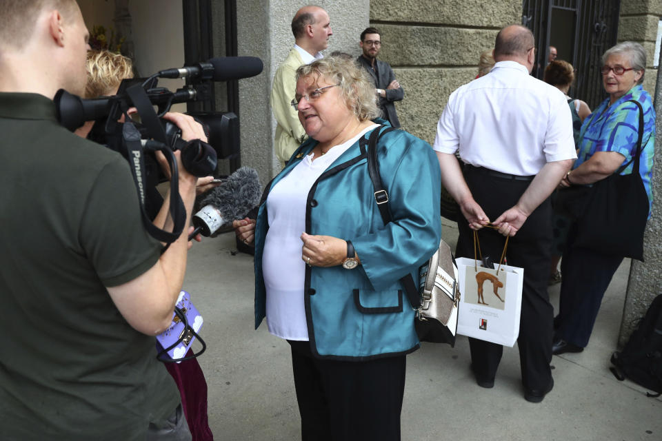 German fan Ingeborg Schaefner answers to questions of AP video journalist Philipp Jenne as she arrives at the 'Festspielhaus' opera house where Placido Domingo will perform 'Luisa Miller' by Giuseppe Verdi in Salzburg, Austria, Sunday, Aug. 25, 2019. Domingo is scheduled to appear onstage at the Salzburg Festival to perform for the first time since multiple women have accused the opera legend of sexual harassment in allegations brought to light by The Associated Press. (AP Photo/Matthias Schrader)