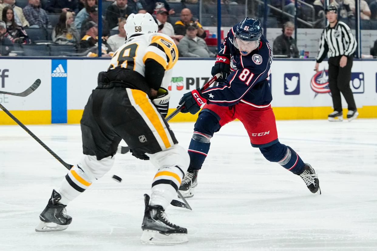 Columbus Blue Jackets defenseman Stanislav Svozil (81) shoots past Pittsburgh Penguins defenseman Kris Letang (58) during the third period of the NHL hockey game at Nationwide Arena on April 13, 2023. The Blue Jackets won 3-2 in overtime.