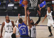 Dallas Mavericks guard Luka Doncic (77) shoots against Los Angeles Clippers forward Marcus Morris Sr. (31) during the second half of Game 5 of an NBA basketball first-round playoff series, Tuesday, Aug. 25, 2020, in Lake Buena Vista, Fla. (Kim Klement/Pool Photo via AP)