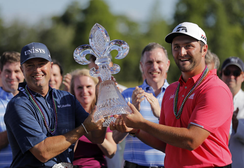 Ryan Palmer, left, and Joh Rahm hold their tournament trophy after winning the PGA Zurich Classic golf tournament at TPC Louisiana in Avondale, La., Sunday, April 28, 2019. (AP Photo/Gerald Herbert)