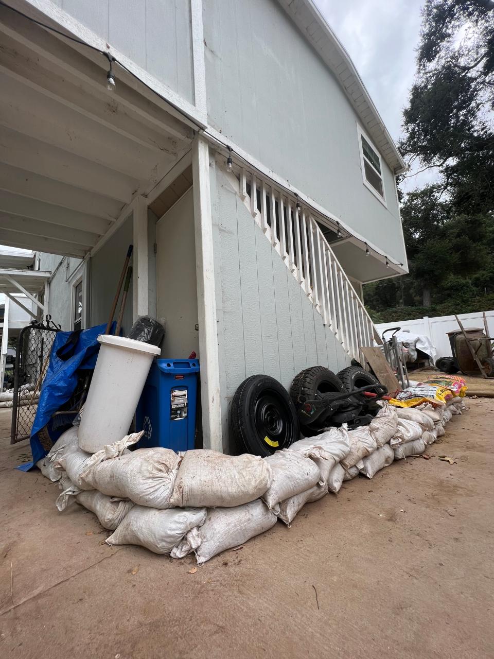 Residents in the Foster Park neighborhood north of Ventura prepared for rain from Tropical Storm Hilary by placing sandbags around homes.