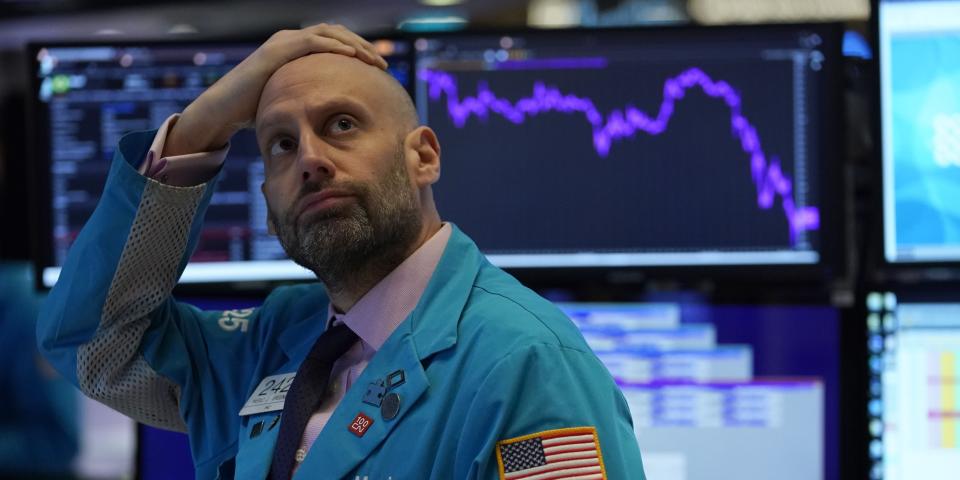 Stock trader rubbing his head