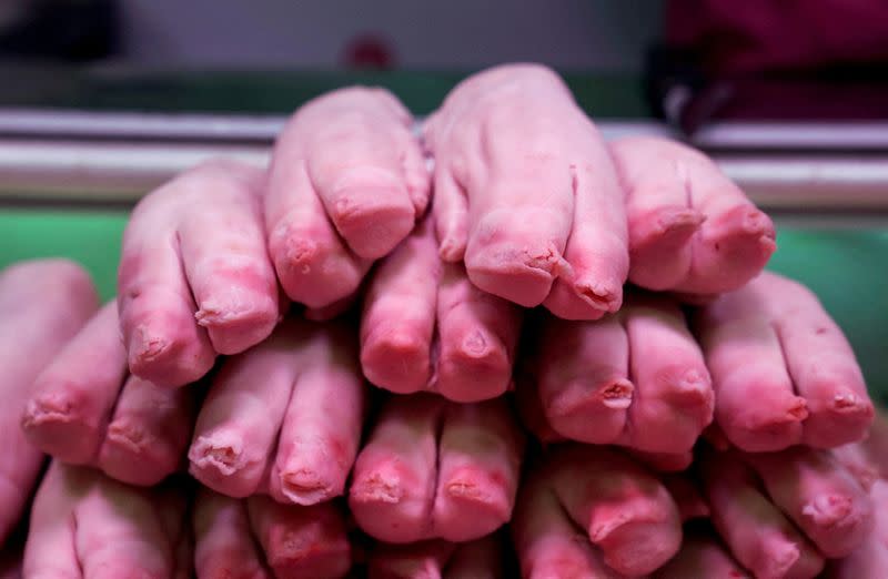 FILE PHOTO: Pig's feet are placed for sale at a market in Beijing