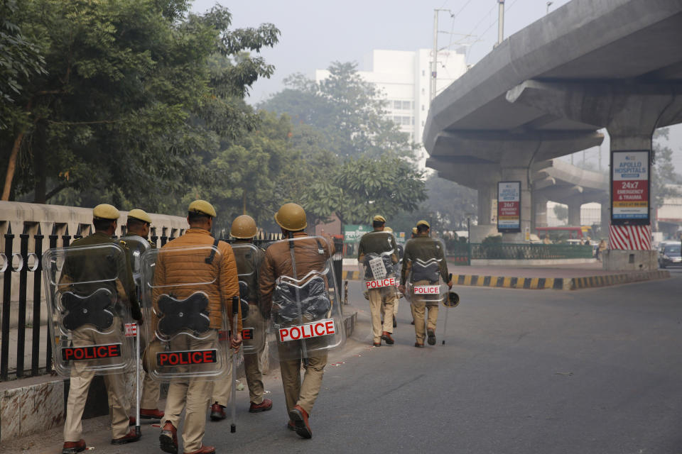 Police patrol a street in Lucknow, Uttar Pradesh state, India, Sunday, Dec. 22, 2019. Violent protests against India's citizenship law that excludes Muslim immigrants have swept the country over the weekend despite the government's ban on public assembly and suspension of internet services in many parts. Police said nine people died in clashes with security forces in Uttar Pradesh on Saturday, most of them young protesters. (AP Photo/Rajesh Kumar Singh)