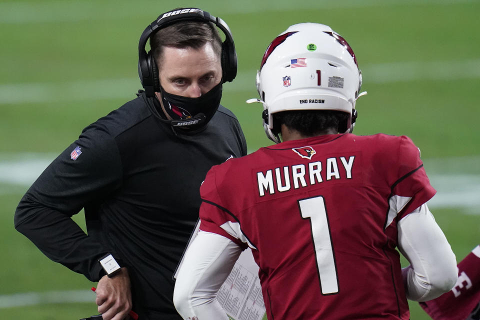 Arizona Cardinals head coach Kliff Kingsbury talks with quarterback Kyler Murray (1) during the second half of an NFL football game against the Philadelphia Eagles, Sunday, Dec. 20, 2020, in Glendale, Ariz. (AP Photo/Ross D. Franklin)