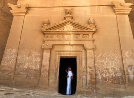 FILE PHOTO: A Saudi tour guide stands inside a tomb at Madain Saleh antiquities site, al-Ula