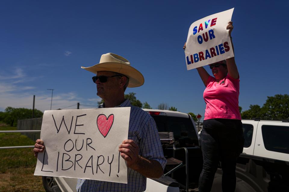 Llano County residents Michael McDavid and Emily Decker protest outside a Commissioners Court meeting April 13. The court met to discuss closing the Llano County library system rather than complying with a judge's order to return several controversial books to the libraries' shelves.