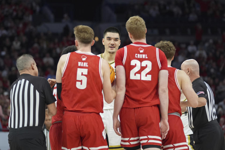 Purdue center Zach Edey, center, gets into an altercation with Wisconsin players during the first half of an NCAA college basketball game in the semifinal round of the Big Ten Conference tournament, Saturday, March 16, 2024, in Minneapolis. (AP Photo/Abbie Parr)