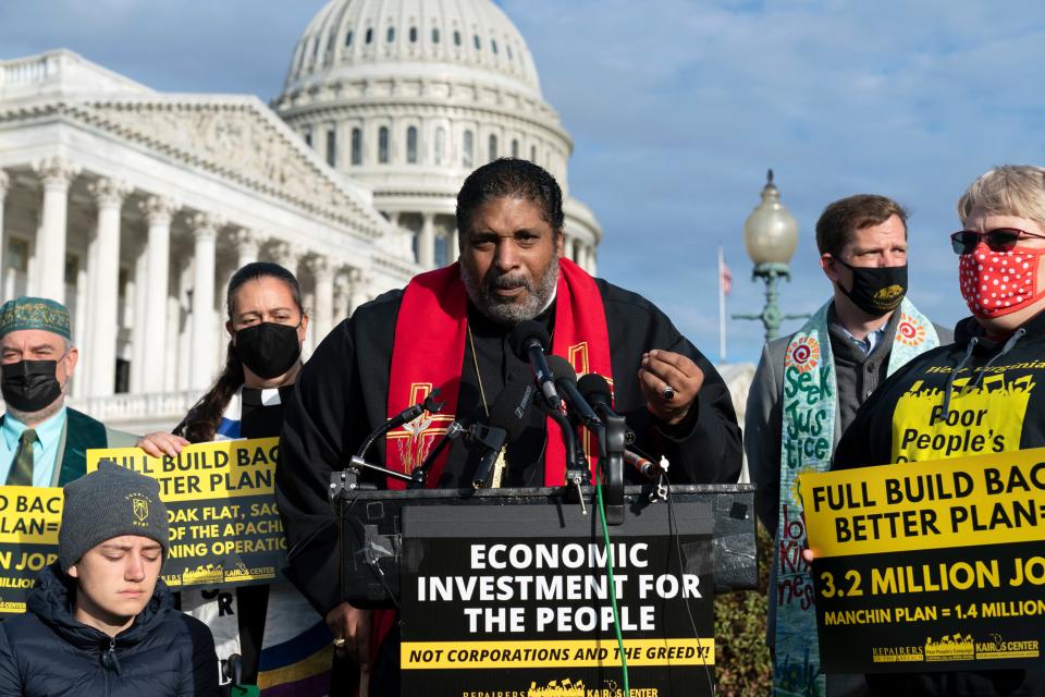 FILE - The Rev. William Barber II and members of the Poor People's Campaign talk to reporters about the need for the "Build Back Better" plan, voting rights, health care, immigrant rights and action on climate change, during a news conference on Capitol Hill in Washington, Oct. 27, 2021. Barber II led the North Carolina NAACP from 2006 to 2017 before resigning to become co-chair of the Poor People's Campaign. (AP Photo/Jose Luis Magana, File)