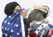 Kaillie Humphries and Kaysha Love, left, from USA celebrate on podium after winning the two-seat bobsleigh world cup in Altenberg, Germany, Sunday, Dec. 5, 2021. (Robert Michael/dpa via AP)