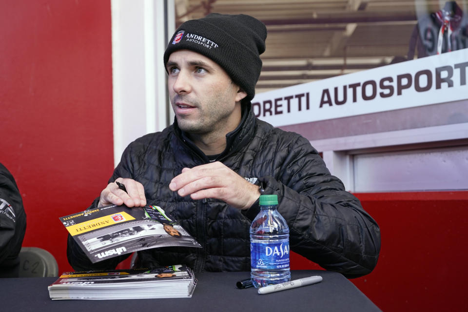 Jarett Andretti signs autographs for fans before the Rolex 24 hour auto race at Daytona International Speedway, Saturday, Jan. 29, 2022, in Daytona Beach, Fla. (AP Photo/John Raoux)