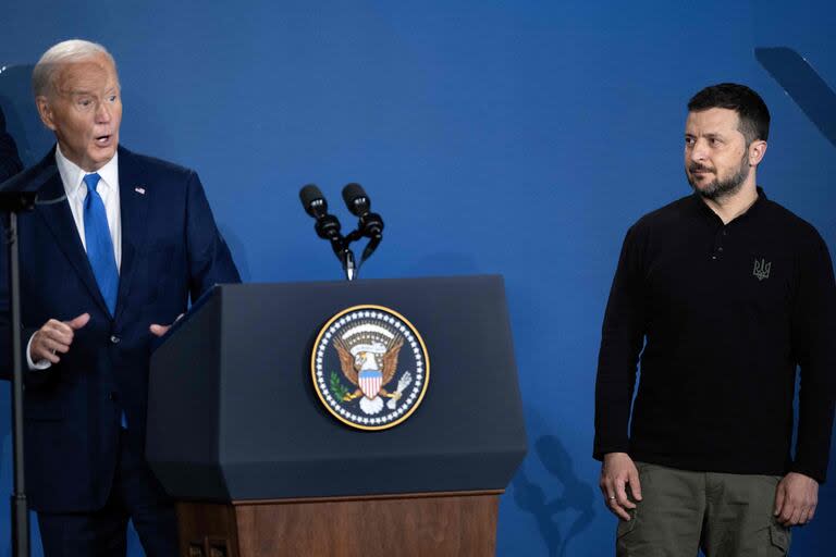 Ukraine's President Volodymyr Zelensky (R) reacts after being introduced as Russia's President Vladimir Putin by US President Joe Biden during a Ukraine Compact event on the sidelines of the NATO members meeting at the Washington Convention Center July 11, 2024, in Washington, DC. (Photo by Brendan Smialowski / AFP)