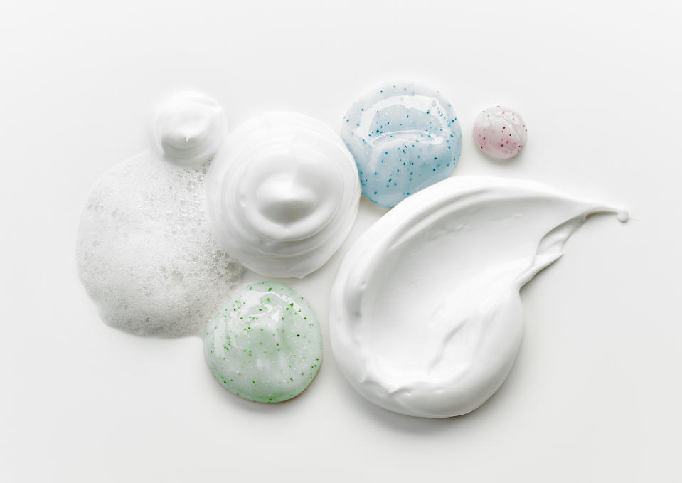 composition of various cosmetic creams on white background, top view