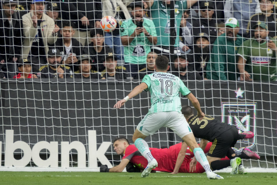 León midfielder Lucas Di Yorio (18) scores a goal against Los Angeles FC goalkeeper John McCarthy, bottom left, during the first half in the second leg of a CONCACAF championship final soccer match Sunday, June 4, 2023, in Los Angeles. (AP Photo/Marcio Jose Sanchez)