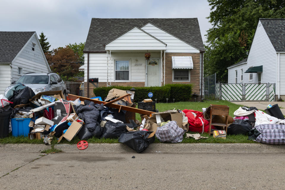 Detroit, Michigan, USA - August 20, 2014: An evicted house at a suburban street with left belongings on the lawns near the 8 mile road, in the city of Detroit.