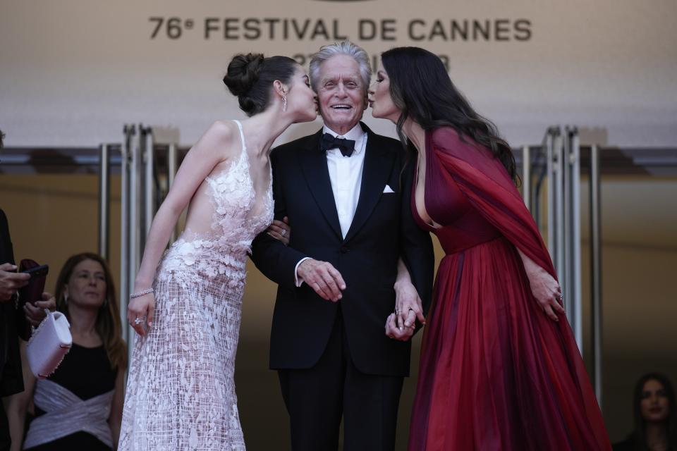 Carys Zeta Douglas, from left, Michael Douglas and Catherine Zeta-Jones pose for photographers upon arrival at the opening ceremony and the premiere of the film 'Jeanne du Barry' at the 76th international film festival, Cannes, southern France, Tuesday, May 16, 2023. (AP Photo/Daniel Cole)