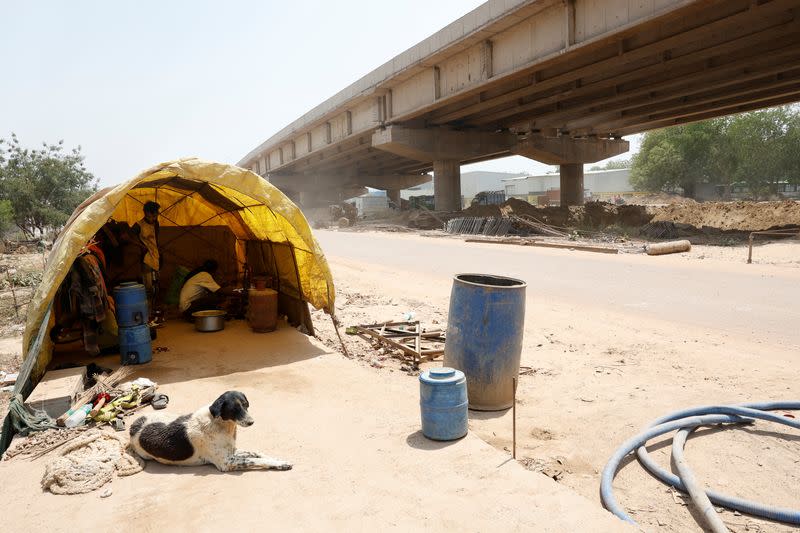 Banwari Singh, 40, a construction worker, cooks food inside his makeshift kitchen at a construction site during a hot summer day in New Delhi