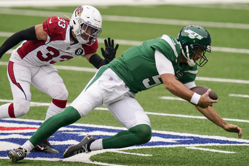 New York Jets quarterback Joe Flacco (5) dives for yardage while under pressure from Arizona Cardinals cornerback Byron Murphy (33) during the first half of an NFL football game, Sunday, Oct. 11, 2020, in East Rutherford. (AP Photo/Seth Wenig)