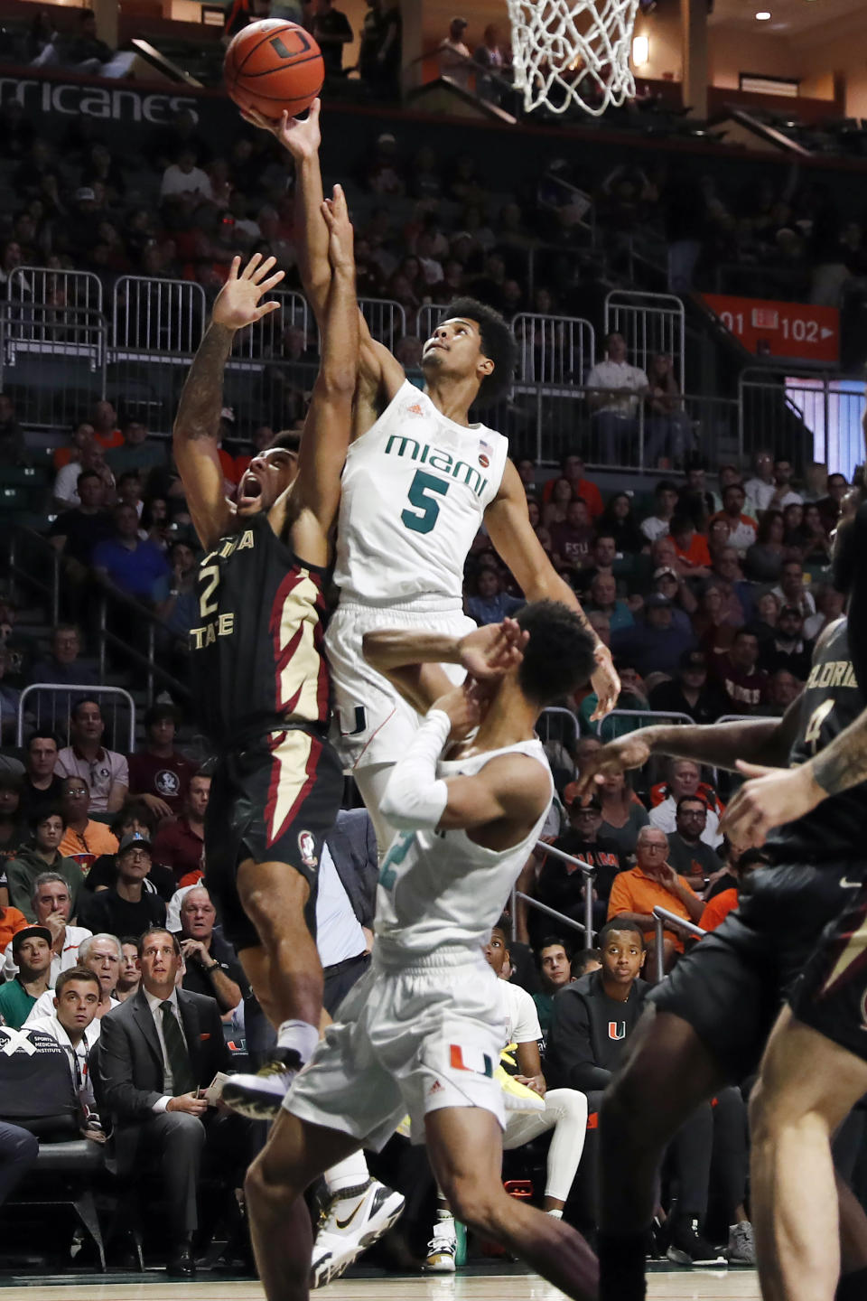 Miami guard Harlond Beverly (5) rebounds the ball against Florida State guard Anthony Polite (2) during the first half of an NCAA college basketball game on Saturday, Jan. 18, 2020, in Coral Gables, Fla. (AP Photo/Brynn Anderson)