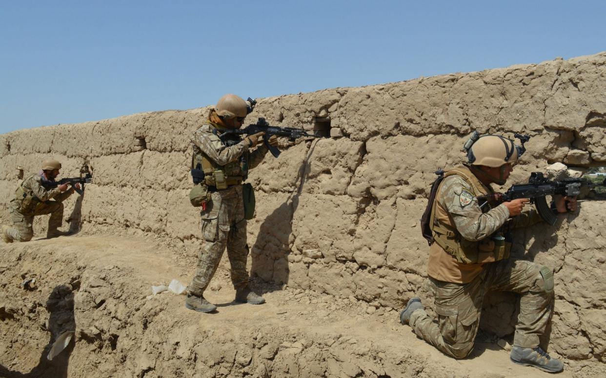 Afghan security forces take position during a battle with the Taliban in Kunduz, which was attacked on August 31. - REUTERS