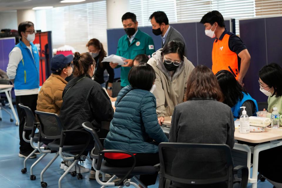 Family members listen to reports for their missing loved ones at a community service center in Seoul (AP Photo/Ahn Young-joon)