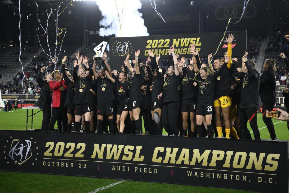 FILE - Portland Thorns FC celebrates with the trophy after the won the NWSL championship soccer match against the Kansas City Current, Saturday, Oct. 29, 2022, in Washington. The owner of the Portland Thorns announced Thursday, Dec. 1, he is putting the club up for sale, the latest fallout from an investigation into misconduct in the National Women’s Soccer League. (AP Photo/Nick Wass, File)