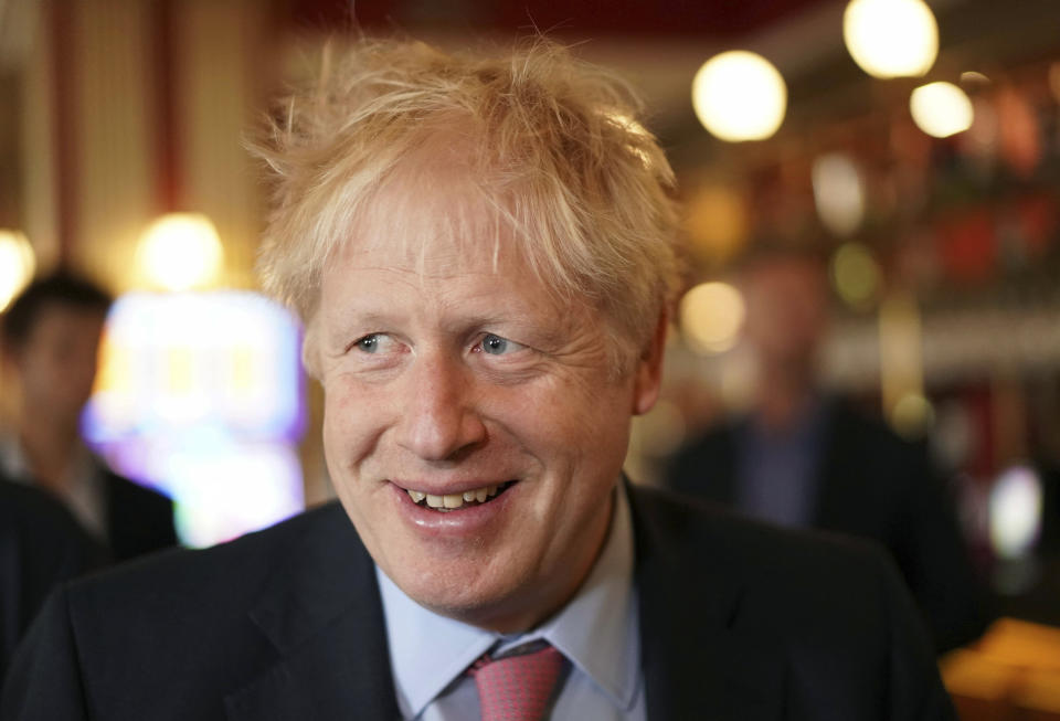 Conservative Party leadership candidate Boris Johnson smiles during a visit to Wetherspoons Metropolitan Bar in London, Wednesday July 10, 2019. (Henry Nicholls/Pool Photo via AP)