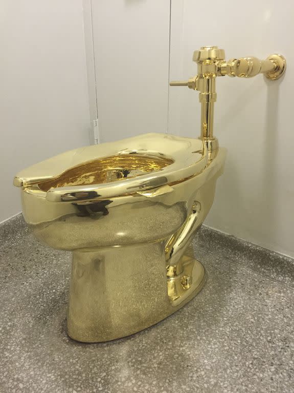 A fully functioning solid gold toilet, made by Italian artist Maurizio Cattelan, is going into public use at the Guggenheim Museum in New York on September 15, 2016.  A guard will be stationed outside the bathroom to protect the work, entitled 'America', which recalls Marcel Duchamp's famous work, 'Fountain'. / AFP / William EDWARDS        (Photo credit should read WILLIAM EDWARDS/AFP/Getty Images)