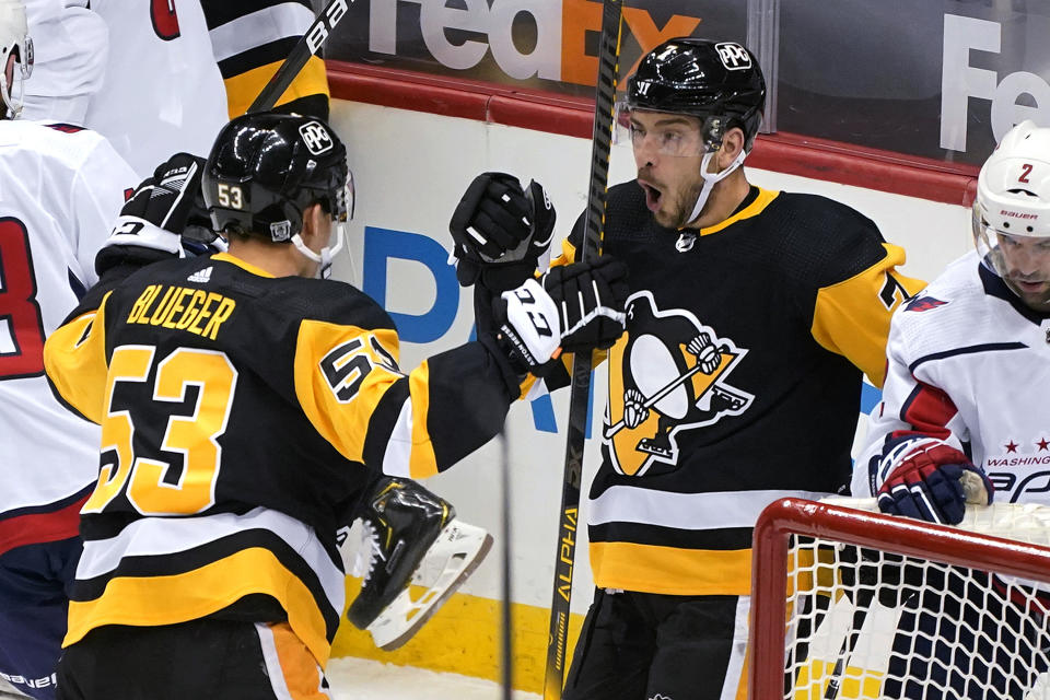 Pittsburgh Penguins' Colton Sceviour (7) celebrates his goal with Teddy Blueger (53) during the first period of the team's NHL hockey game against the Washington Capitals in Pittsburgh, Tuesday, Jan. 19, 2021. (AP Photo/Gene J. Puskar)