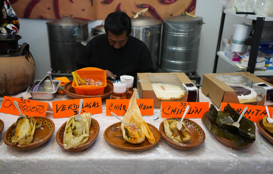 Tamales of different styles are displayed on a table during the tamales fair at the Ixtapalapa neighborhood of Mexico City, Friday, Jan. 27, 2023. A single offering of the dish is called a tamal in Spanish. It comes from the Nahuatl word "tamalli," which means wrapped. (AP Photo/Fernando Llano)