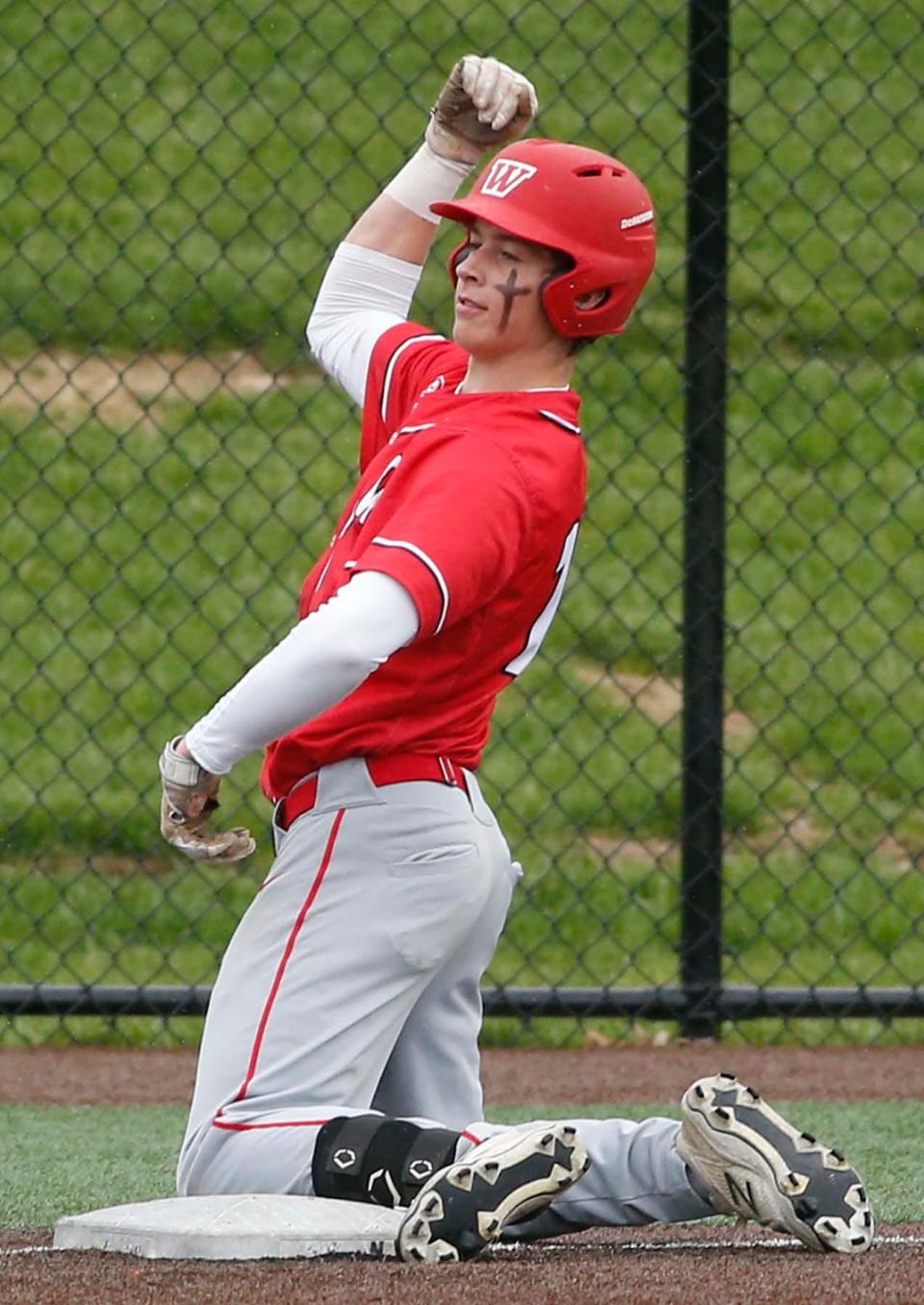 Aaron Keating of Wadsworth celebrates his triple after sliding into third base during their game against Stow at the University of Akron on Thursday.