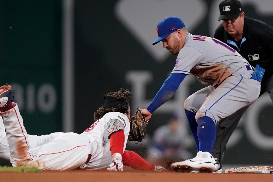 Boston Red Sox's Triston Casas, left, slides out at second as New York Mets'  Danny Mendick, right, tags him in the fifth inning of a baseball game, Sunday, July 23, 2023, in Boston.