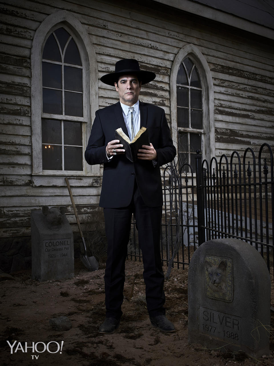 <p>The reverend (Yul Vazquez, <i>The Good Wife</i>), who appears to take his clothing cues from Johnny Cash, is a quiet thinking man most often seen pouring over his <i>Bible</i> or taking meticulous care of the church’s pet cemetery. It’s as if he is performing some intense self-imposed penance, which likely has something to do with the fact that he disappears every time there’s a full moon rising. Owusu-Breen teases, “The payoff is so much cooler than your run-of-the-mill werewolf. Shooting the episode where we find out what he is was the coolest thing I have ever been a part of. I could have happily retired.”<br>(Photo: Virginia Sherwood/NBC) </p>