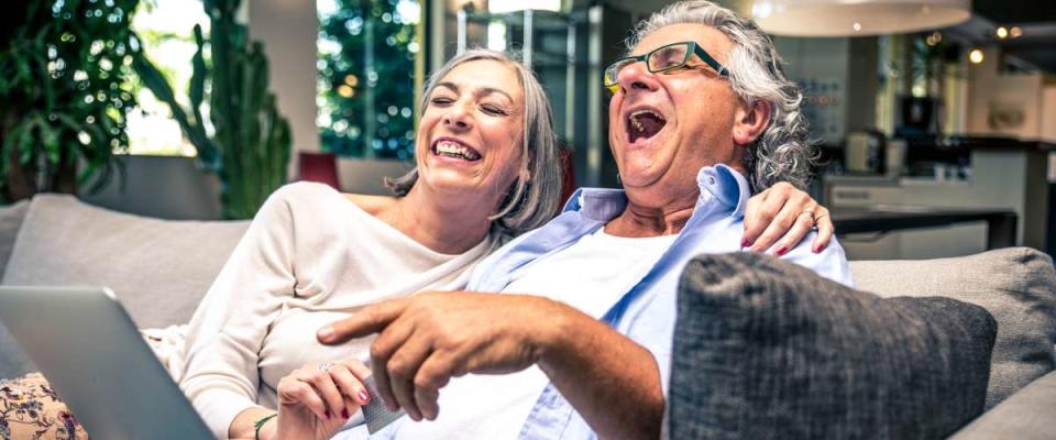 senior couple using a laptop at home