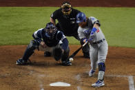 Los Angeles Dodgers' Justin Turner hits a double against the Tampa Bay Rays during the third inning in Game 3 of the baseball World Series Friday, Oct. 23, 2020, in Arlington, Texas. (AP Photo/Sue Ogrocki)