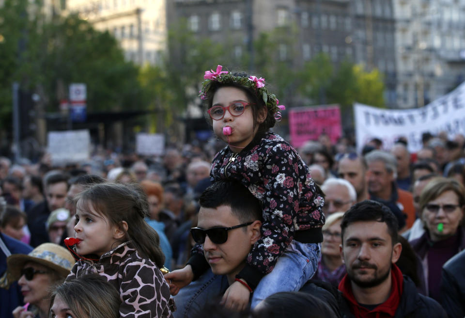 A girl blows a whistle during a protest march against President Aleksandar Vucic in Belgrade, Serbia, Saturday, April 20, 2019. Thousands of people have rallied in Serbia's capital for 20th week in a row against populist President Aleksandar Vucic and his government. (AP Photo/Darko Vojinovic)
