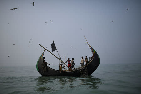 Rohingya refugees crew a fishing boat in the Bay of Bengal near Cox's Bazaar, Bangladesh, March 24, 2018. REUTERS/Clodagh Kilcoyne