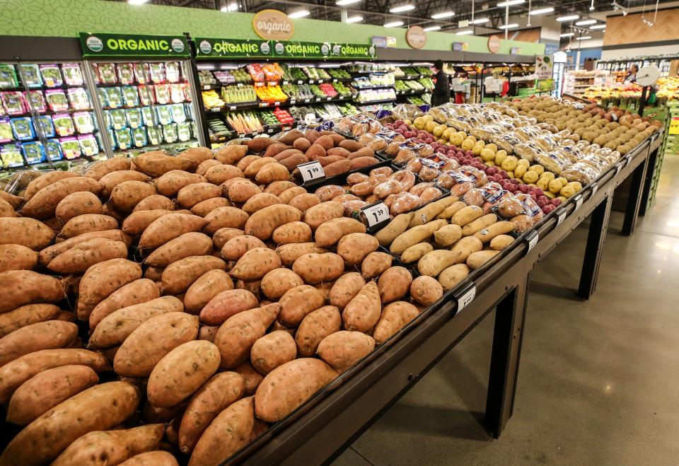 Sweet potatoes, pictured inside a Kroger grocery store earlier this month in Missouri, are among the popular foods for Thanksgiving side dishes that have increased in price in the last year. However, costs for turkeys, the main course for many Americans, have slightly fallen.