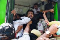 Police push Congress Party activists into a bus after detaining them during an anti-government demonstration to protest against the recent passing of new farm bills in parliament in New Delhi on September 28, 2020. (Photo by Sajjad HUSSAIN / AFP) (Photo by SAJJAD HUSSAIN/AFP via Getty Images)