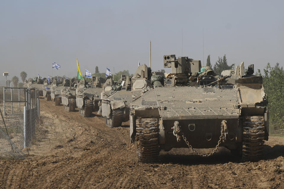 A convoy of Israeli army vehicles maneuvers near Israel's border after leaving Gaza, southern Israel, on Friday, Nov. 24, 2023. Friday marks the start of a four-day cease-fire in the Israel-Hamas war, during which the Gaza militants pledged to release 50 hostages in exchange for 150 Palestinians imprisoned by Israel. (AP Photo/Tsafrir Abayov)